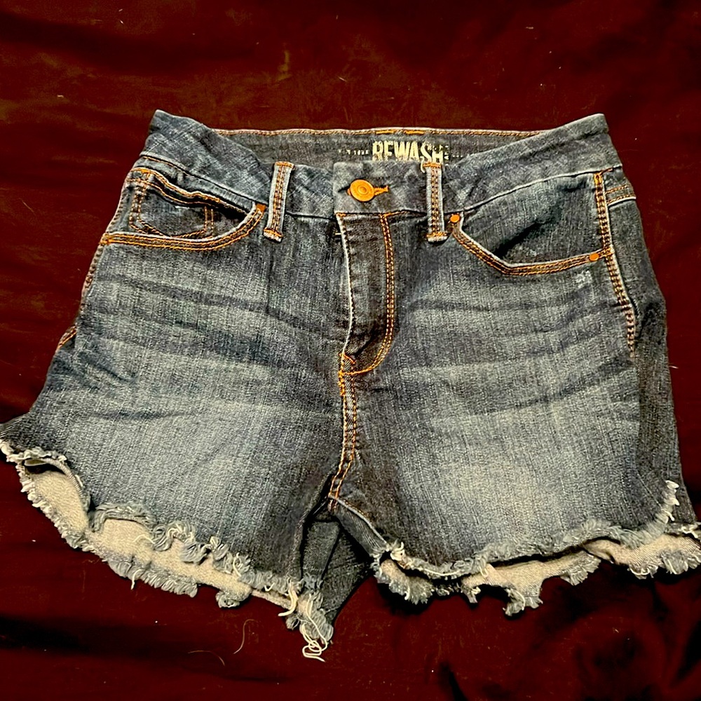 High rise, dark Jean shorts era with frayed ends. Size 0